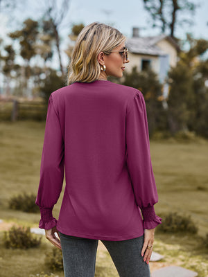 Fuchsia long sleeve blouse with pleated yoke and shirred cuffs.