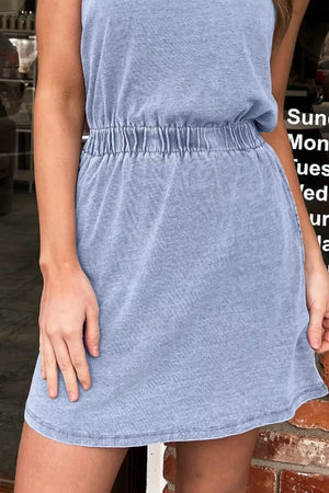 Light blue denim mini dress with elastic waist and short sleeves.