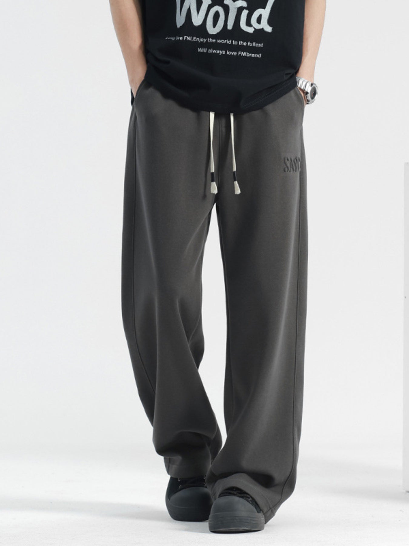 Men's grey casual drawstring sweatpants with embroidered logo detail.