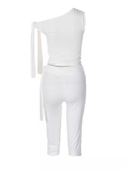 White one-shoulder tie top and capri set with a draped waist detail.