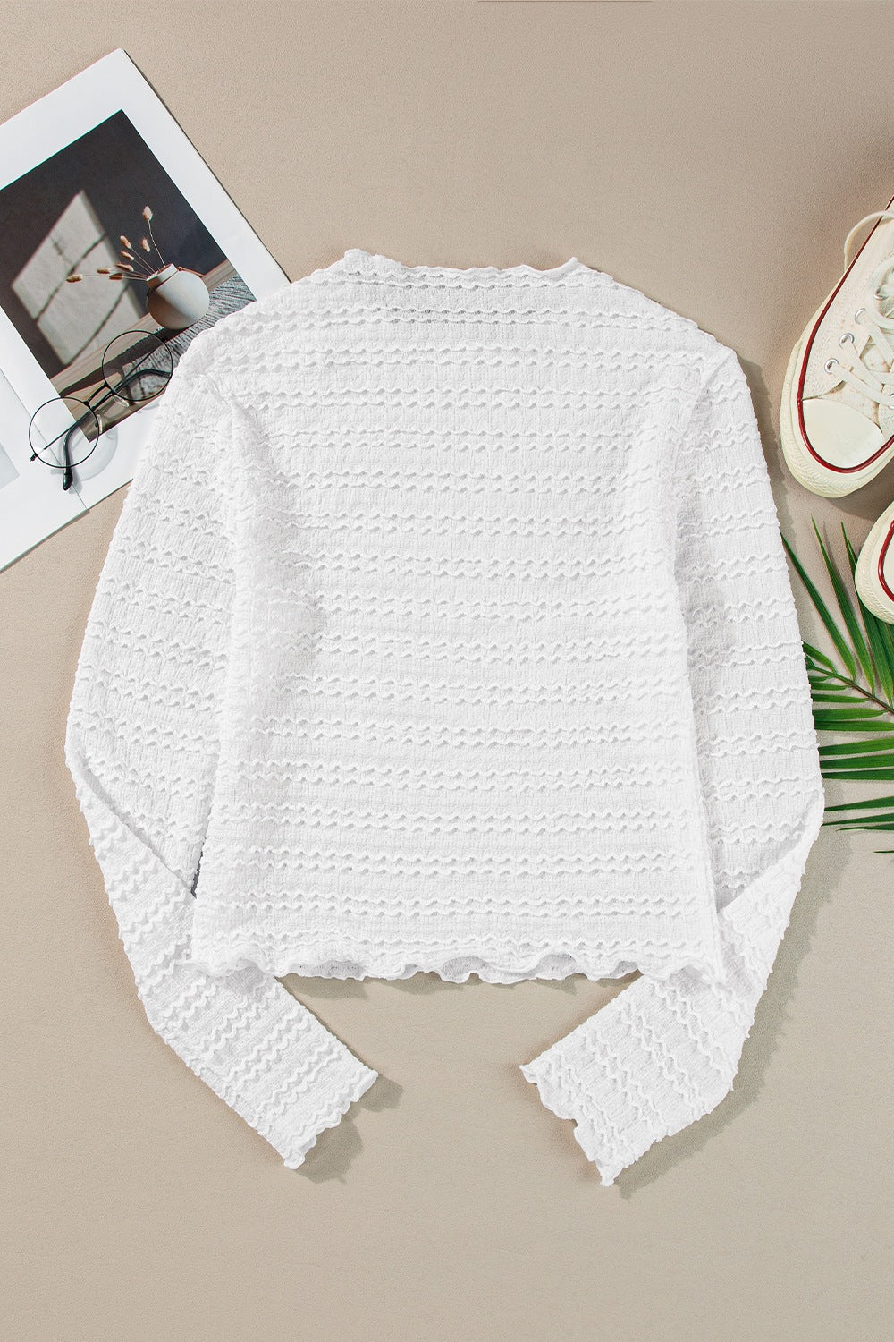 White textured long sleeve top with ruffle trim and scalloped hem