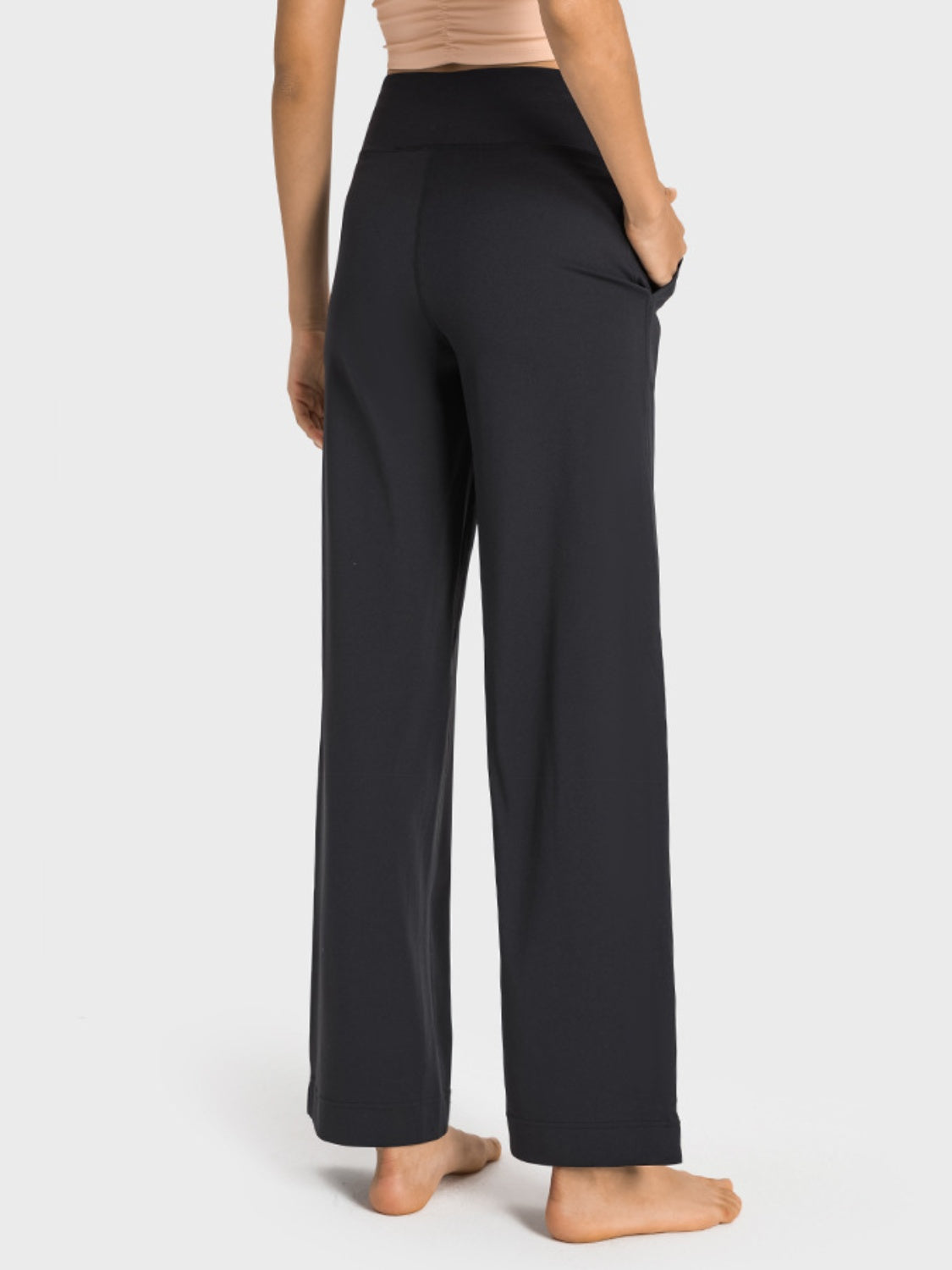 Black wide-leg jogger trousers with pockets and a high waist.