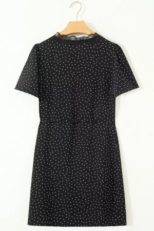 Black polka dot mini dress with short sleeves and lace neckline detail