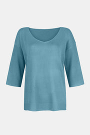 Pastel blue knit sweater with V-neck and flared 3/4 sleeves.
