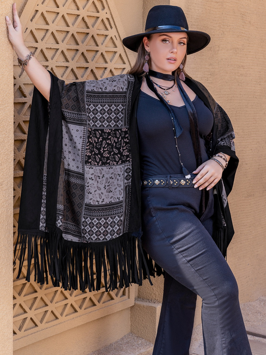 Black patchwork print kimono with fringe detail and boho styling.