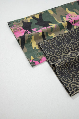 Contrast patchwork jeans with camouflage and leopard print, featuring pink floral accents.