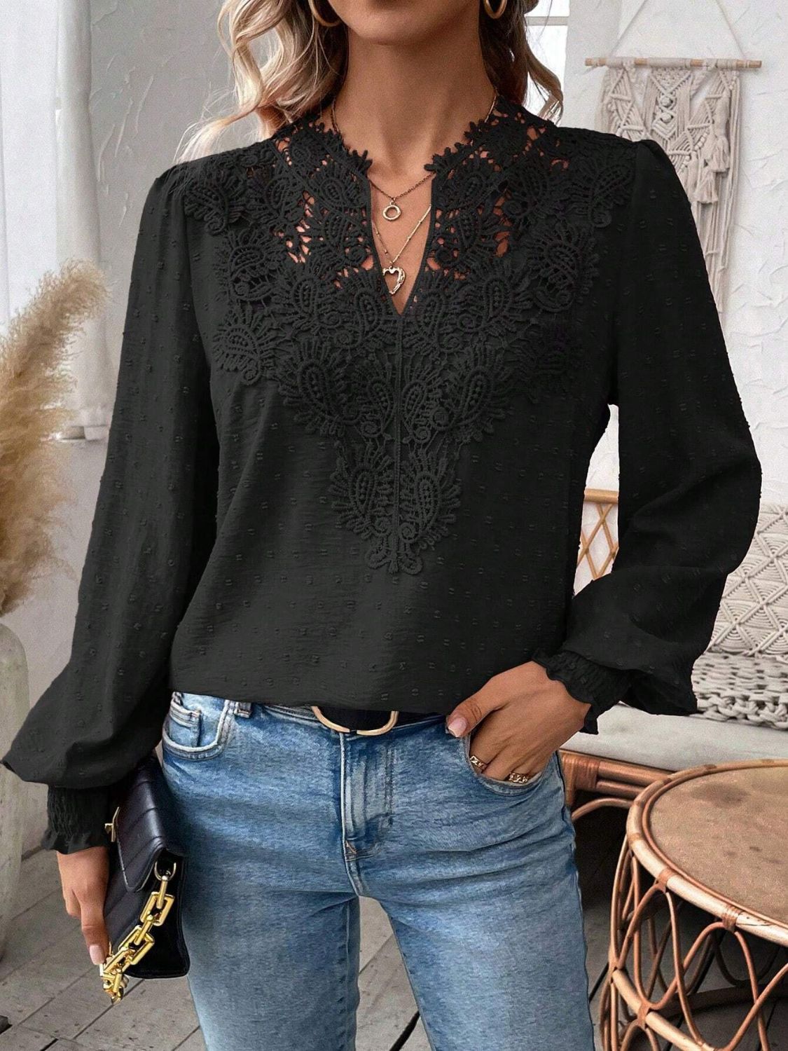 Black embroidered yoke blouse with puff sleeves and textured fabric