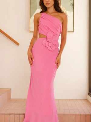 Pink one-shoulder maxi dress with floral appliqué and cutout detail.