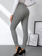 Plaid high waist slim fit ankle length pants in black and white with decorative buttons.