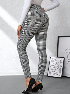 Plaid high waist slim fit ankle length pants in black and white with decorative buttons.
