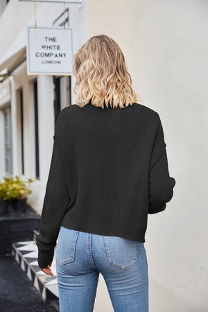 Black textured knit cropped cardigan with button detail.