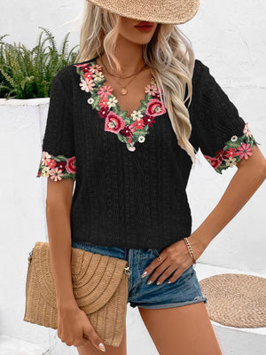 Black embroidered eyelet v-neck peasant top with floral trim on neckline and sleeves