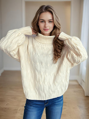 Ivory oversized cable knit turtleneck pullover sweater with ribbed cuffs and hem.