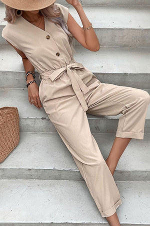 Tan button-front sleeveless jumpsuit with sash tie and cuffed ankles