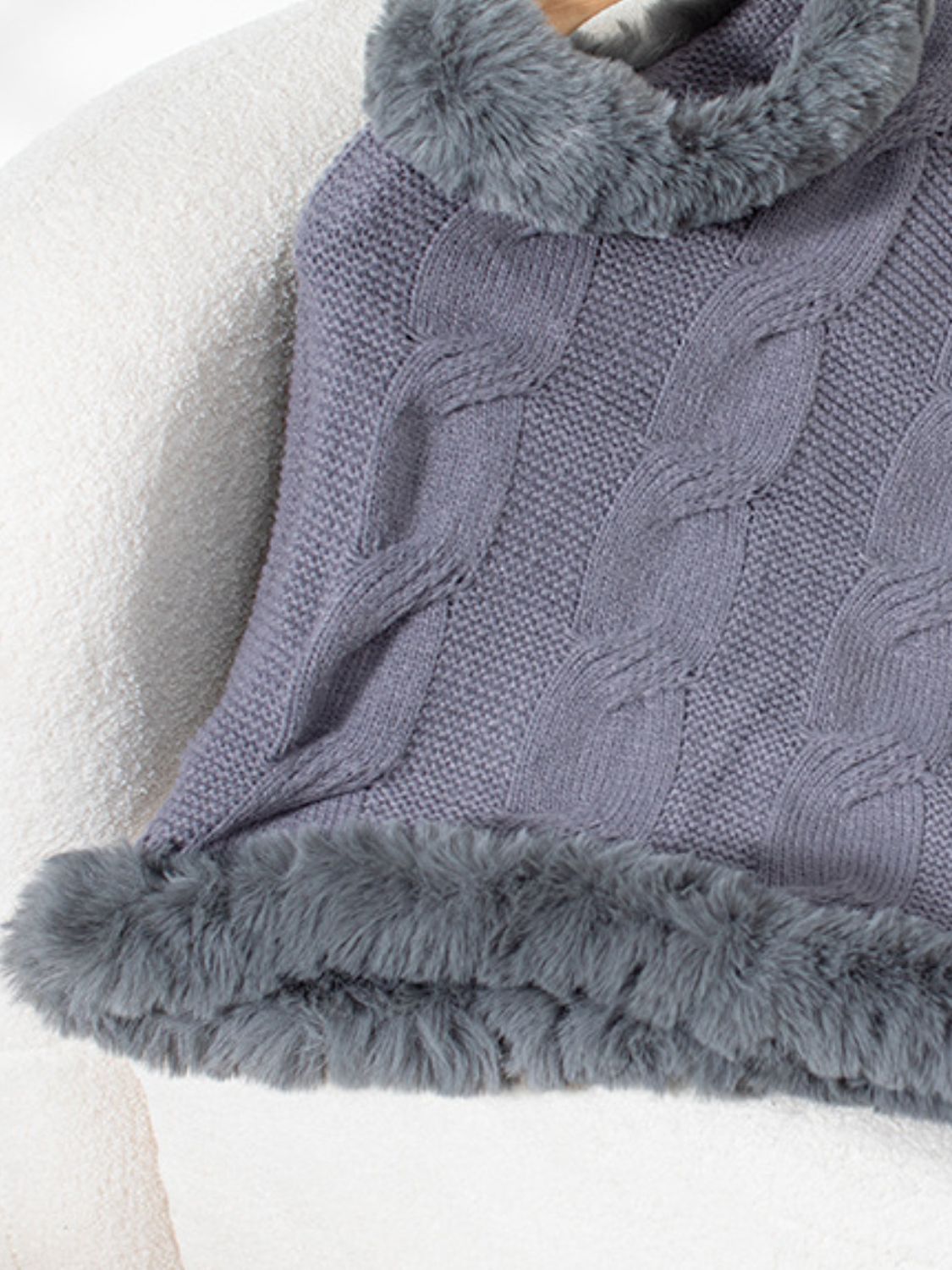 Dark Gray cable knit poncho with faux fur trim and detailed texture.