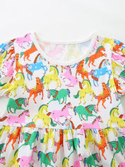 Toddler cotton dress with playful multi-color horse print and puff sleeves.