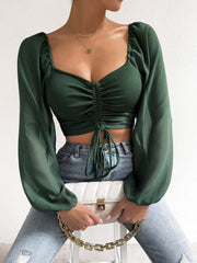 Ruched bodice puff sleeve crop top in army green with tie detail and square neckline.