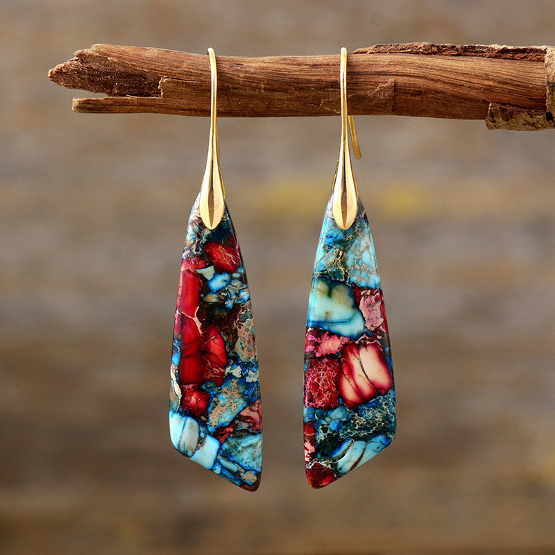 Marbled stone teardrop earrings in red and blue with gold accents.