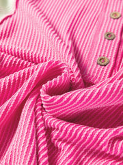Fuchsia pink henley t-shirt with textured stripes and wooden buttons.