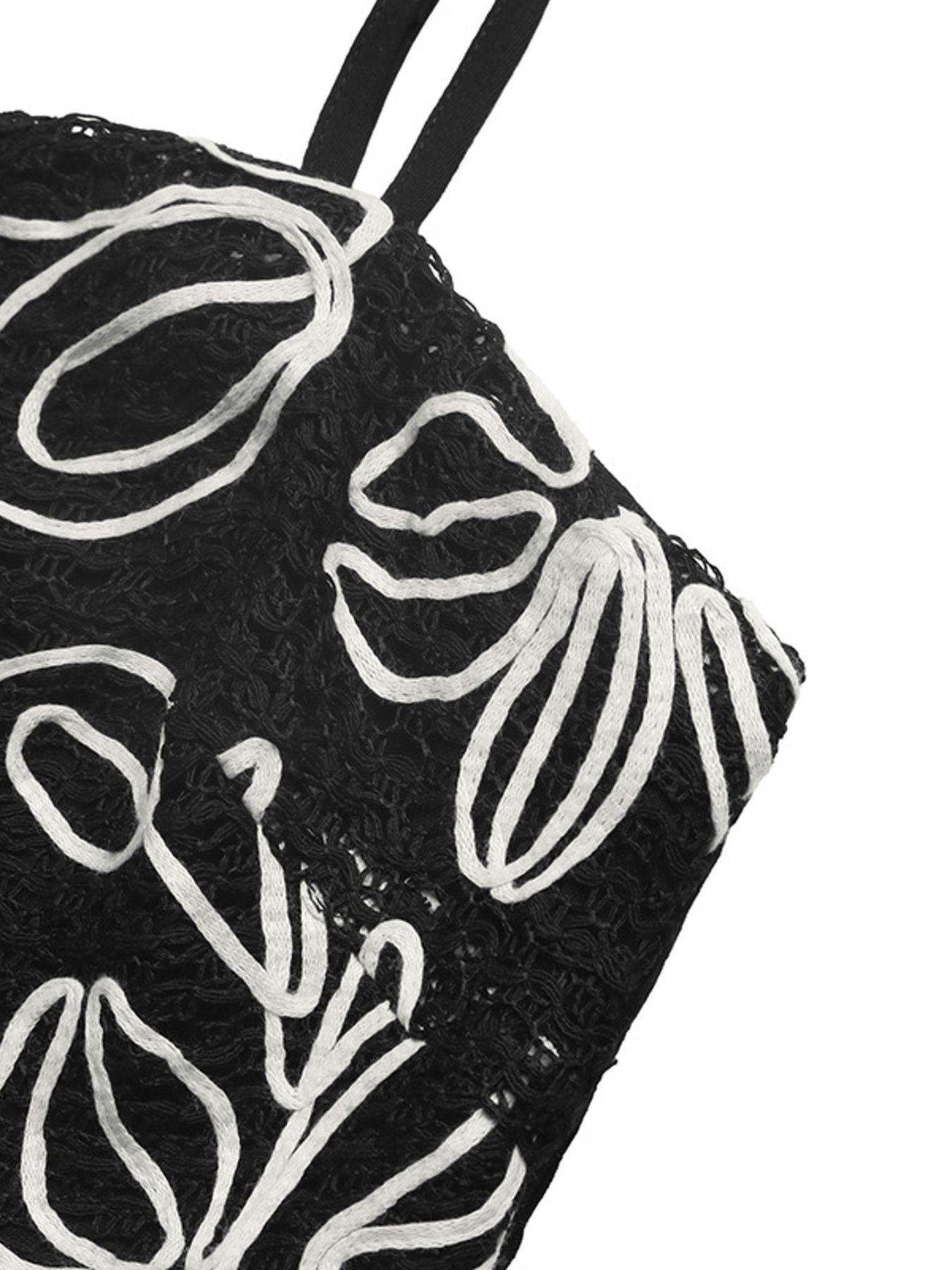 Black cami top with white floral embroidery and spaghetti straps.