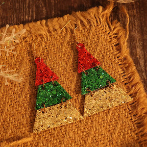 Festive glitter tiered Christmas tree earrings in red, green, and gold.