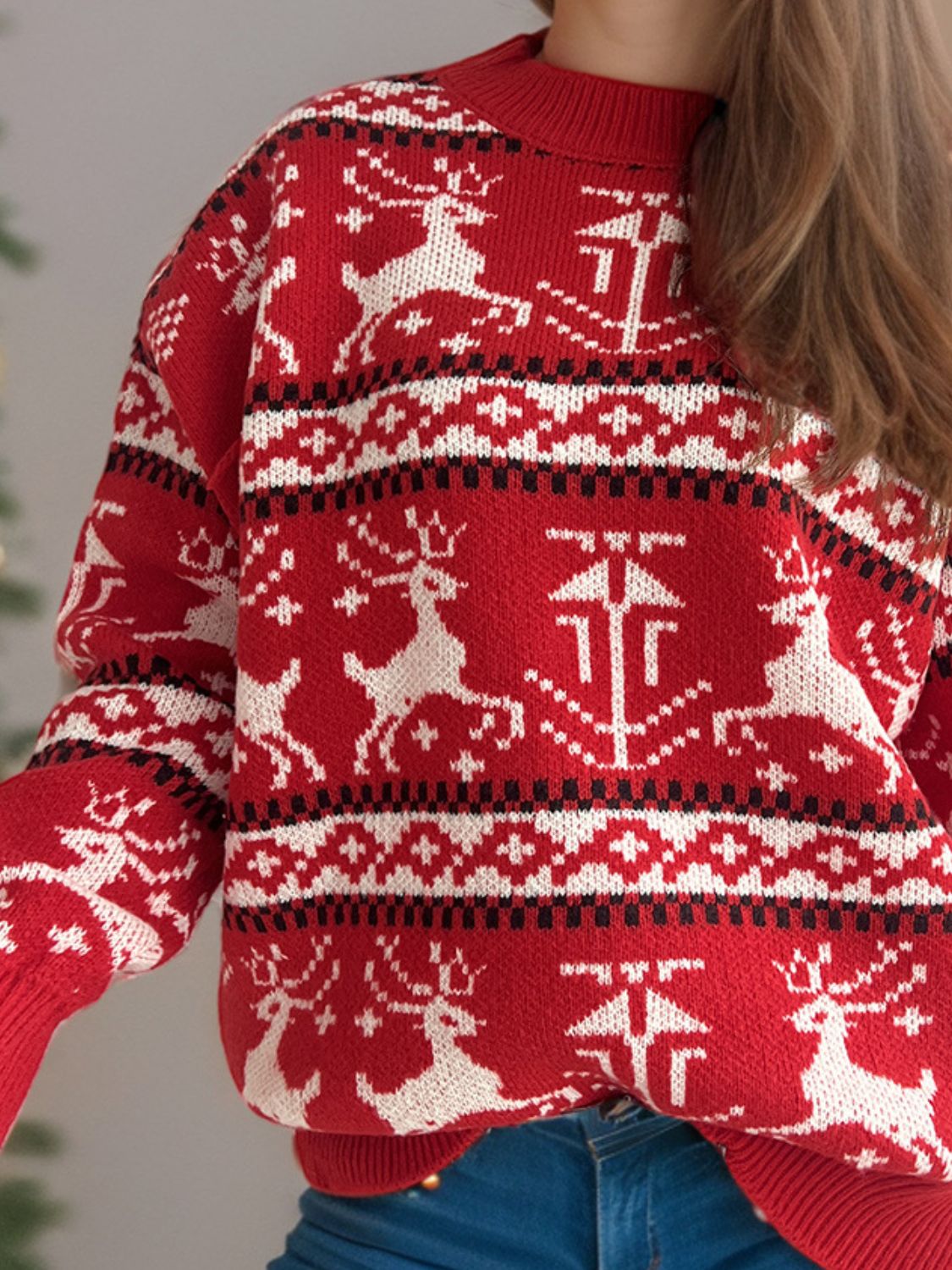 Reindeer Fair Isle crew neck sweater in deep red acrylic with white and black pattern.