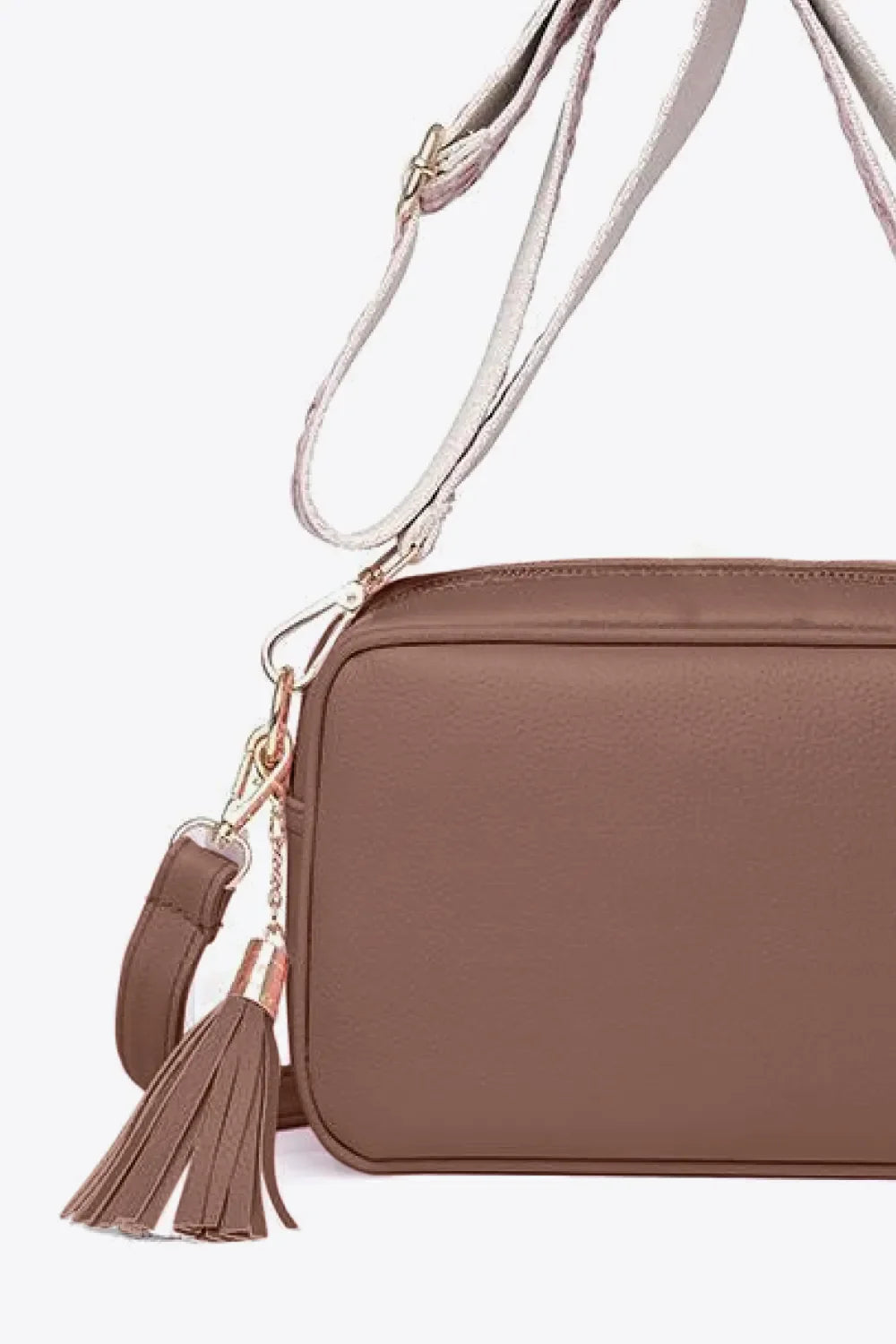 Textured crossbody bag in brown with tassel detail and adjustable strap