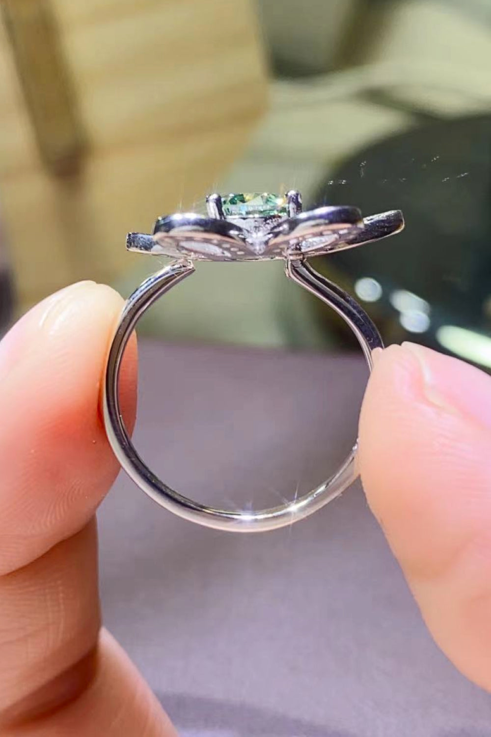 Petal halo ring with light green moissanite and silver band.
