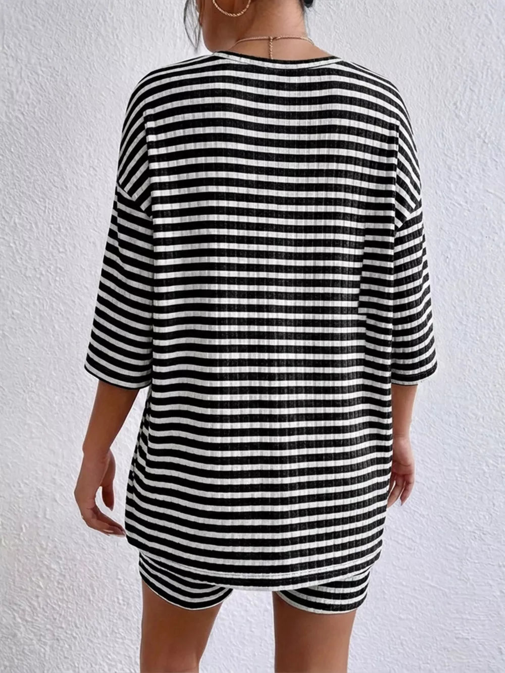 Chic striped two-piece set in black stripes with elbow sleeves and shorts.