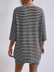 Chic striped two-piece set in black stripes with elbow sleeves and shorts.