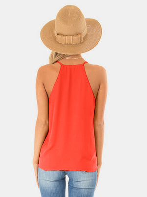 Orange halter cami with crossover neckline detail.