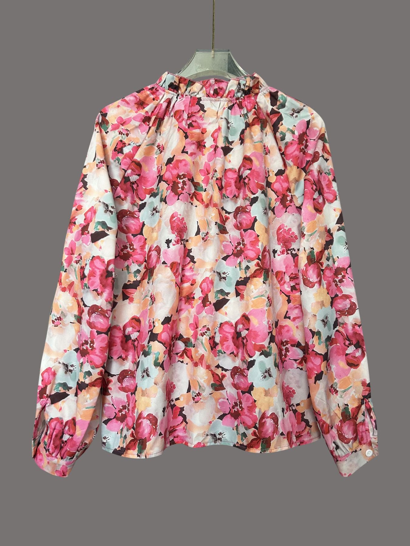 Frill trim button-up shirt with a vibrant floral print, featuring a high neckline and long sleeves.
