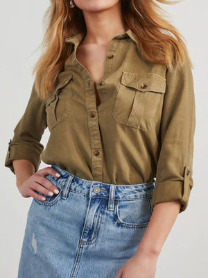 Olive brown washed denim utility shirt with buttoned chest pockets and rolled sleeves.