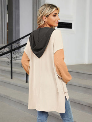 Waffle knit colorblock tunic with contrast sleeves and hood, side pockets.
