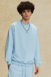 Light blue oversized crewneck sweatshirt with subtle shoulders and crew neckline.