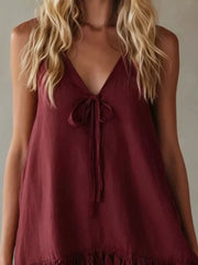 Burgundy tie-front mini dress with V-neck and ruffle hem.