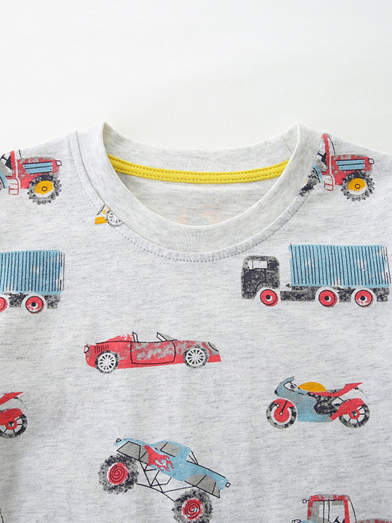 Toddler grey cotton t-shirt with a playful vehicle print, featuring trucks, cars, and motorcycles.