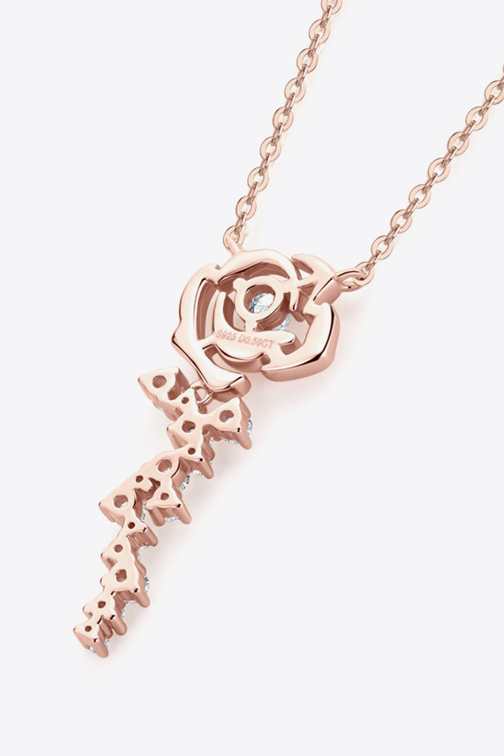 Rose gold necklace with rose pendant and cascading cubic zirconia details.