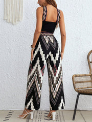 Black geometric print crop top and wide leg pants set with embroidered straps.