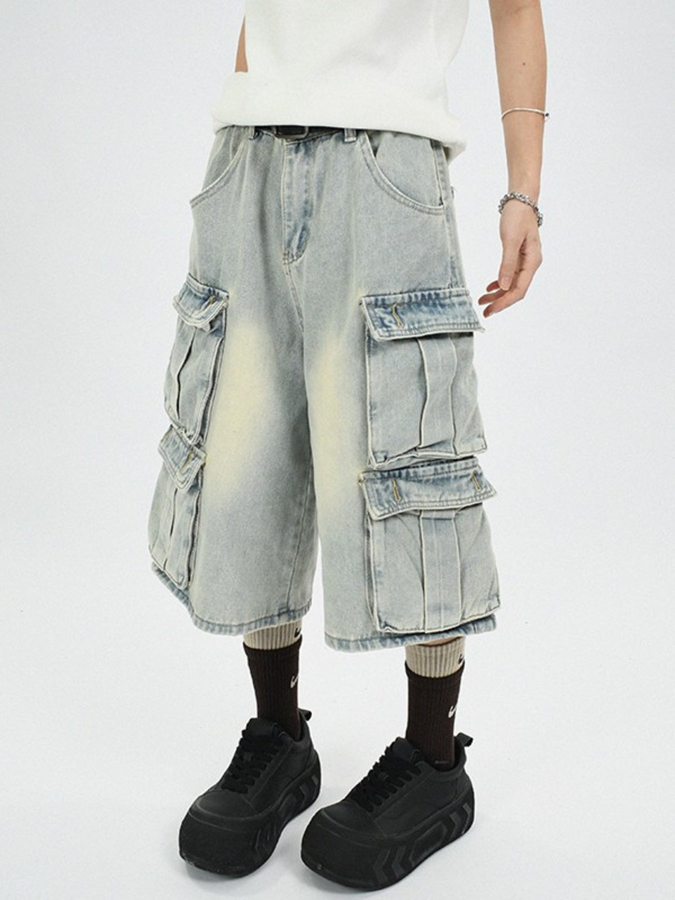 Men's light wash denim capri cargo pants with multiple pockets and a relaxed fit.