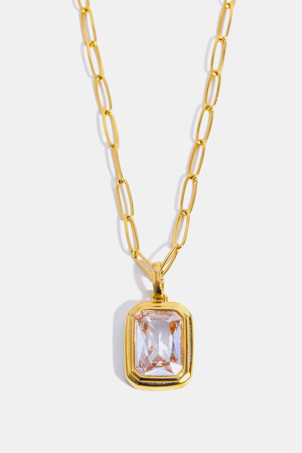 18K gold necklace with a transparent rectangular pendant and paperclip chain.