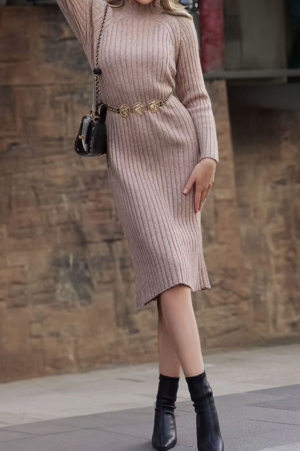 Tan ribbed midi dress with mock neck and long sleeves, cinched with a gold coin belt.