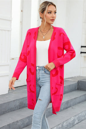 Hot pink knit cardigan with red leopard motif, open front, long sleeves, and pockets.