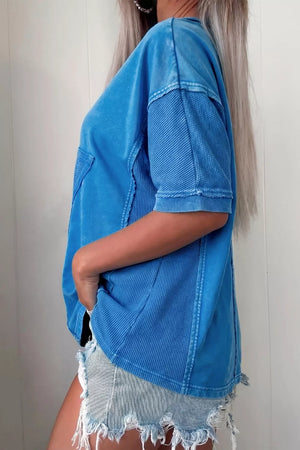 Blue mineral wash cotton tee with patchwork details and short sleeves.