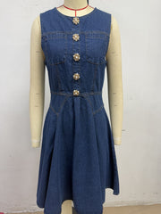 Denim A-line dress with decorative pearl buttons and chest pockets.