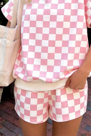 Chic checkerboard blush pink and white bikini shorts with elastic waistband.