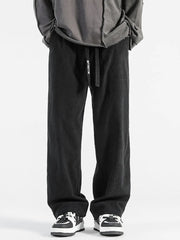 Black corduroy wide-leg sweatpants with drawstring waist and vertical ribbing.