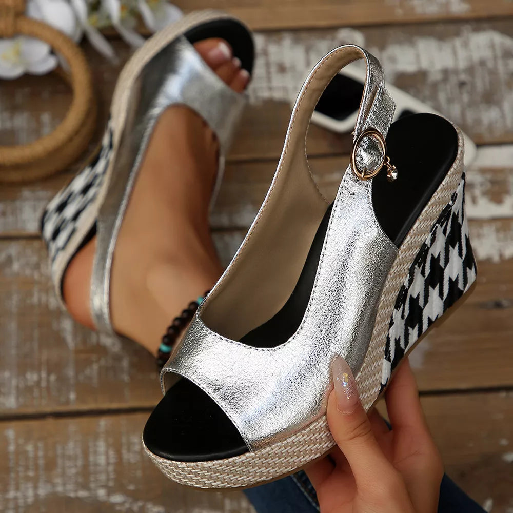 Sleek open-toe wedge sandals in silver with decorative buckle and houndstooth wedge.