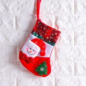 Festive Christmas stocking with snowman face, red plaid cuff, and green tree applique.