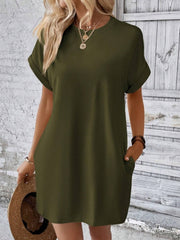 Army green relaxed tee dress with cuffed sleeves and pockets, styled casually.